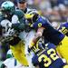 Michigan safety Jordan Kovacs and cornerback J.T. Floyd take down Michigan State tailback Le'Veon in the first quarter at Michigan Stadium on Saturday afternoon. Melanie Maxwell I AnnArbor.com